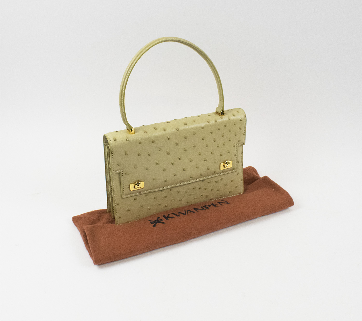 KWANPEN OSTRICH HANDBAG, gold tone hardware with single top handle, flip  lock closures at the front, cream leather lining, with two sections and two  internal pockets one with zip, plus and external