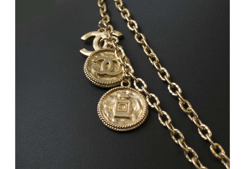 CHANEL 'COIN' NECKLACE, gold tone, plus a pair of matching earrings. (3)