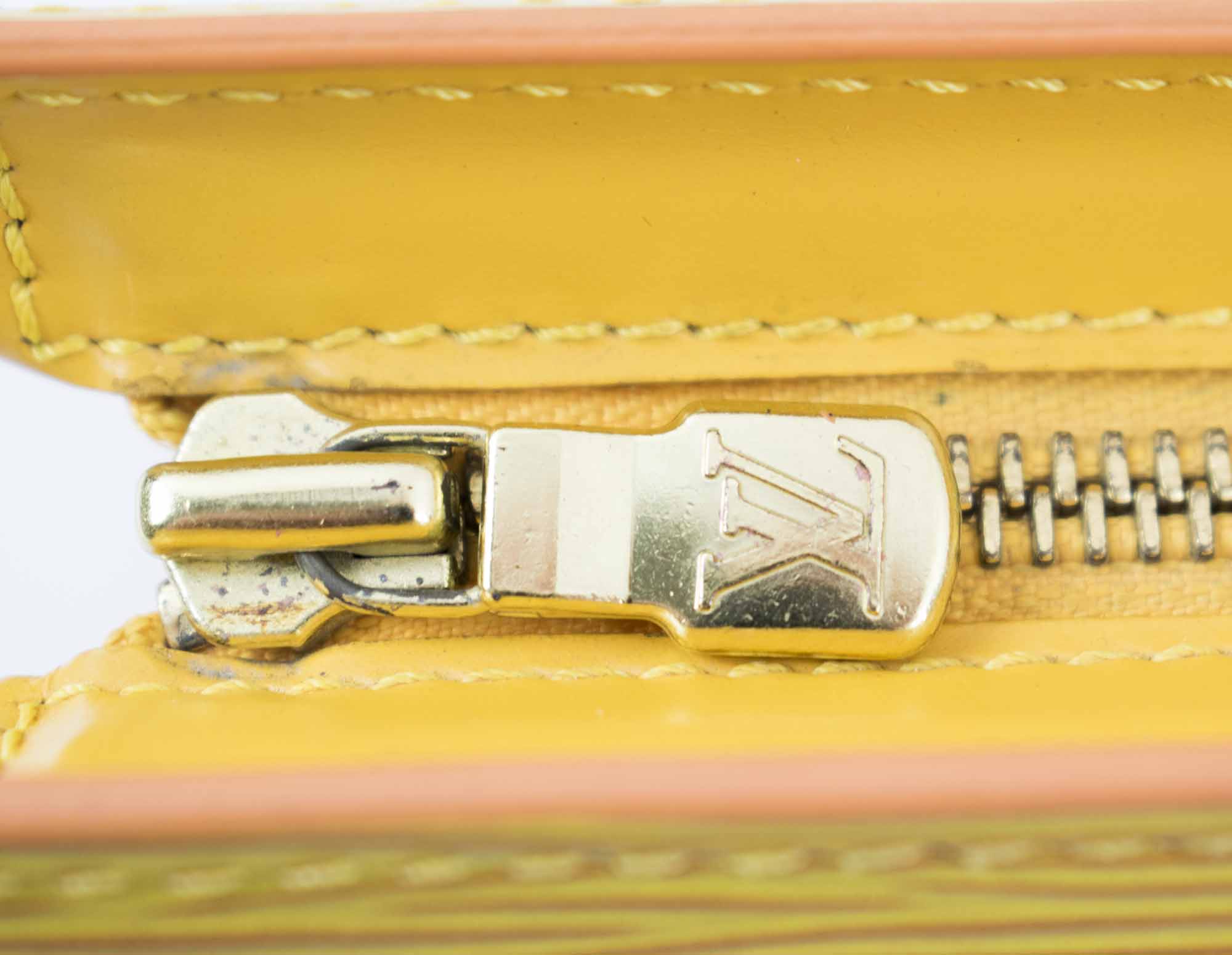 LOT:353  LOUIS VUITTON - a yellow Epi Sac Triangle handbag.