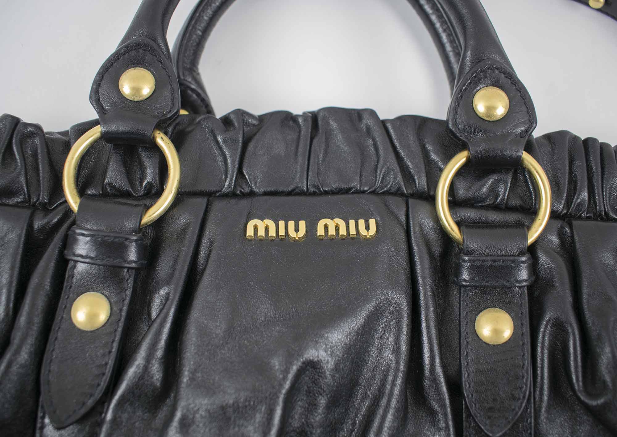 MIU MIU VITELLO LUX GATHERED TOTE BAG, black leather with detachable  shoulder strap, brass tone hardware, pleated leather closure, two top  handles with dust bag, 40cm x 34cm H x 15cm.