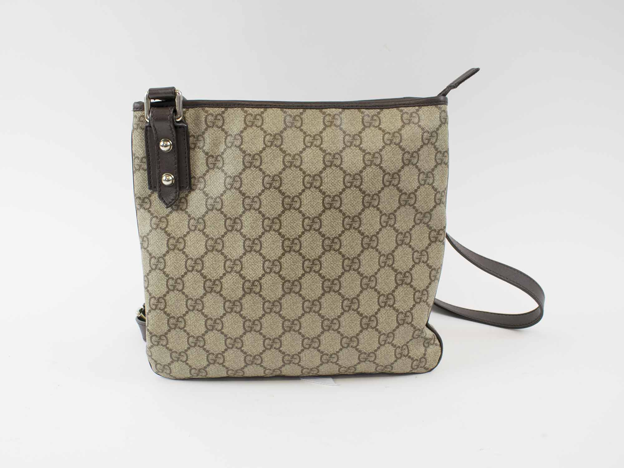 GUCCI CROSSBODY VINTAGE FLAT MESSENGER BAG, with iconic GG monogram canvas,  leather trims and adjustable strap, top zip closure, 25cm x 23cm H.