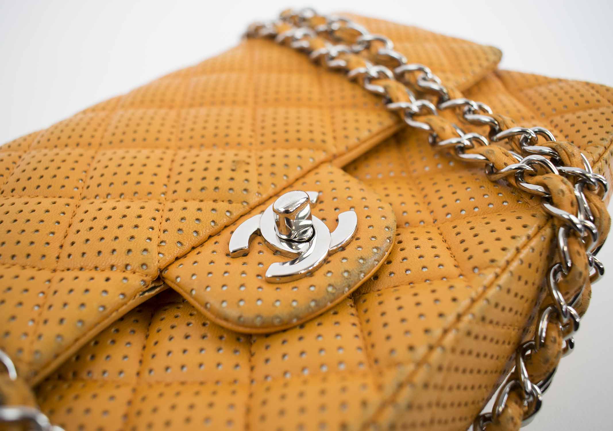 CHANEL LAMBSKIN PERFORATED DOUBLE FLAP BAG, with iconic diamond orange  quilted perforated leather, with silver tone hardware and CC turn lock,  orange leather lining, 2006-2008, authenticity card, 26cm x 15cm H.