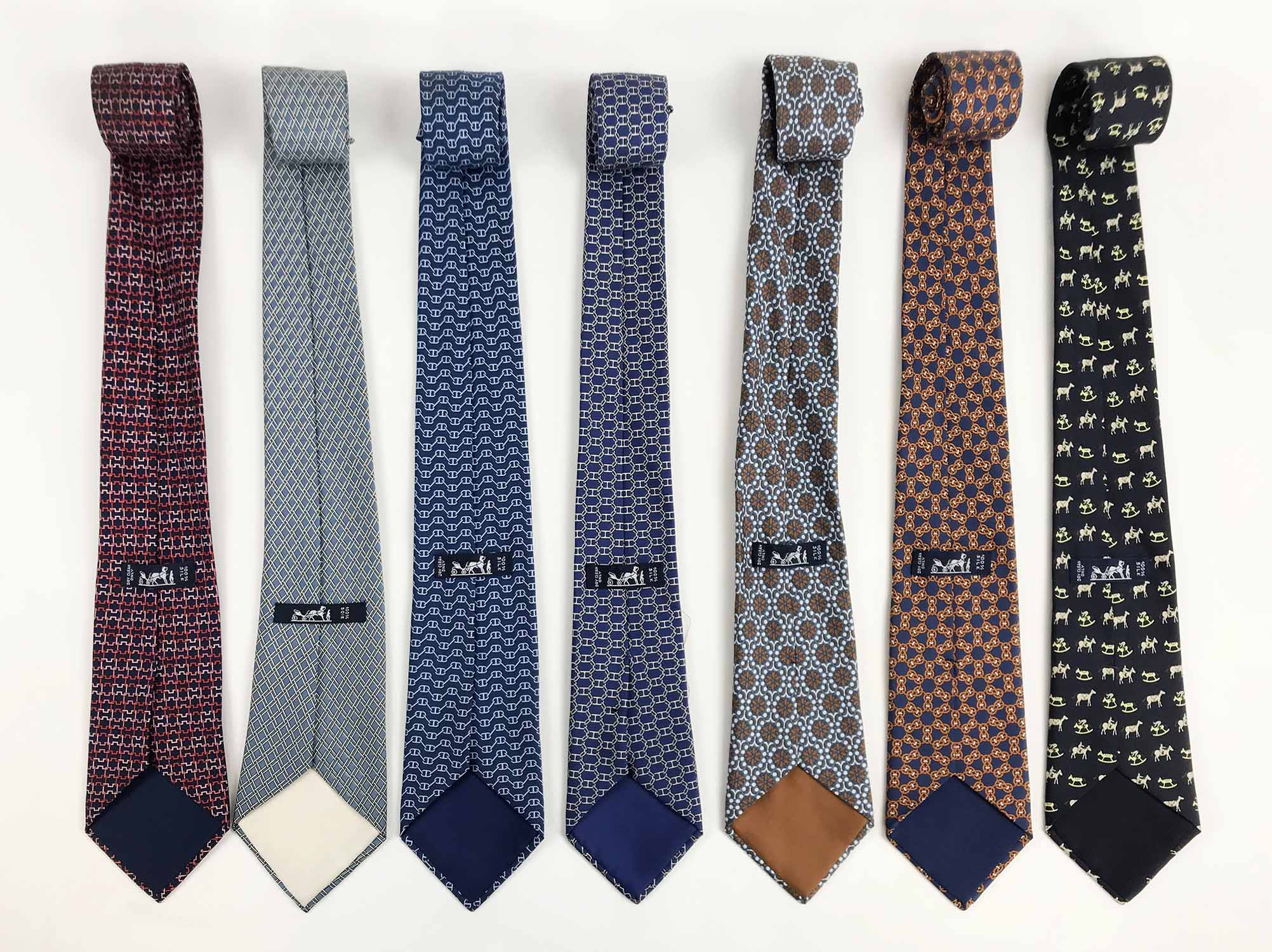 HERMÈS TIES, a collection of seven patterned silk ties. (7)