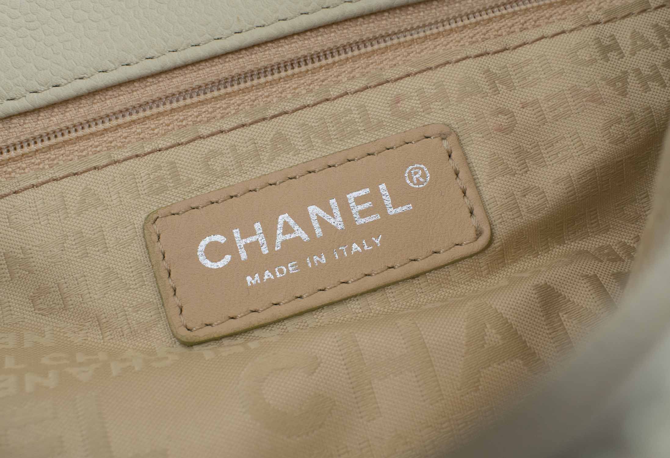 CHANEL TOTE HANDBAG, flap closure with iconic CC logo at the front,  interwoven leather and chain strap with shoulder pad, fabric lining with  zipper pocket, silver tone hardware, authenticity card 2004/2005, with