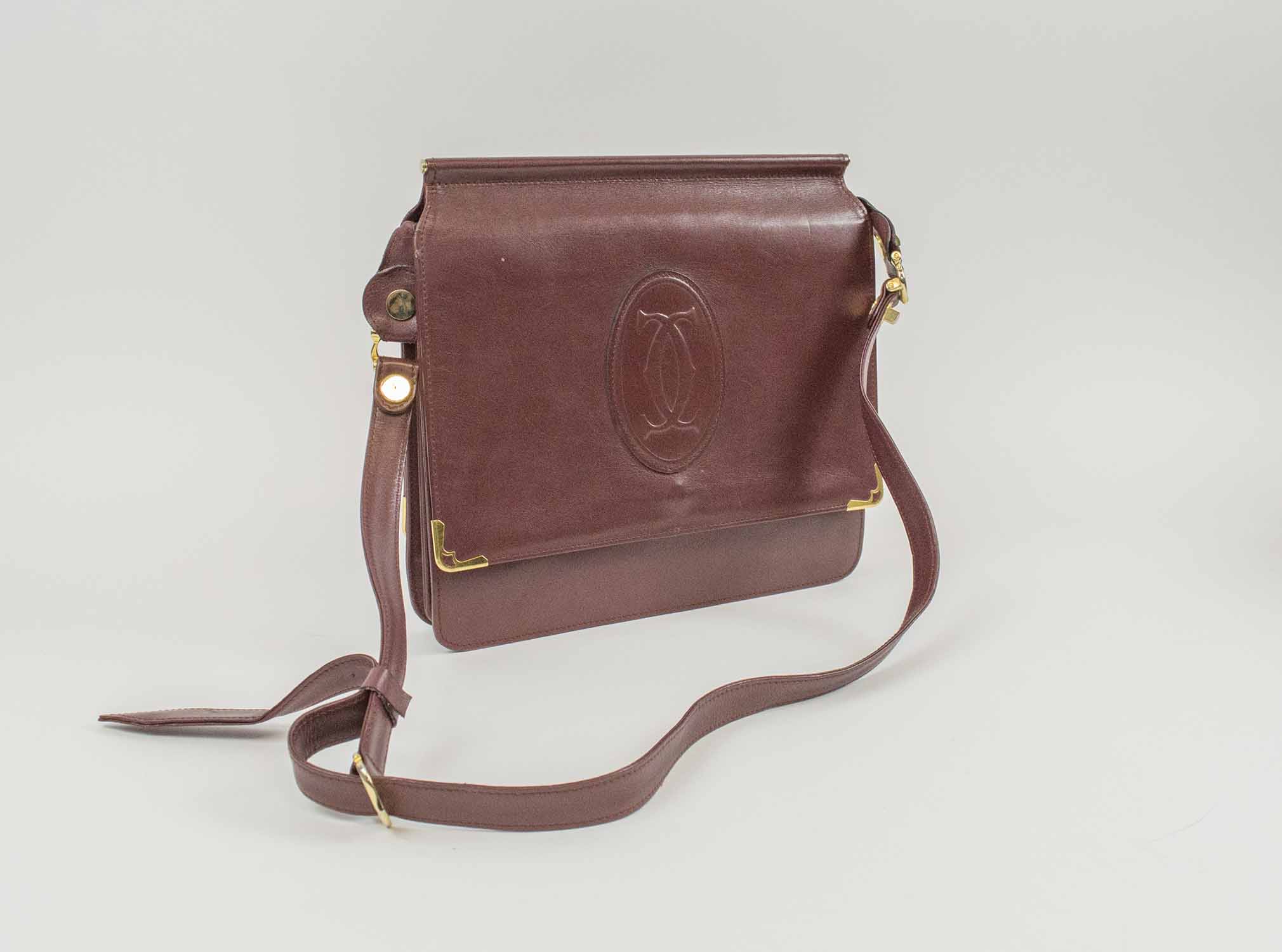 Cartier Vintage Handbag Burgundy Leather With Iconic Logo At The Front Front Flap Closure Gold Tone Hardware Adjustable Shoulder Strap Back Pocket Matching Leather Lining 25cm X 24cm H X 5cm