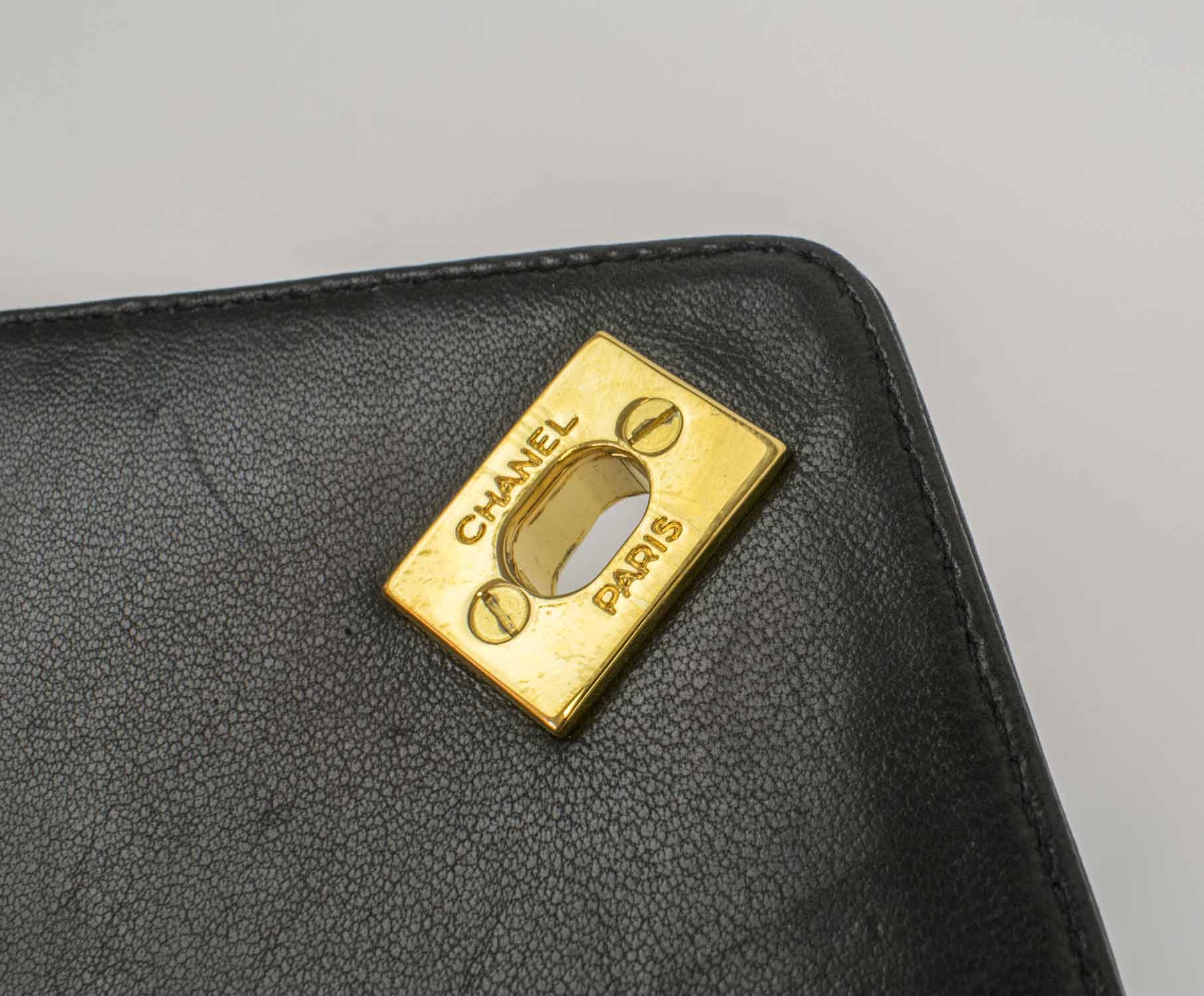 CHANEL CAMERA VINTAGE CHEVRON BAG, with top zip closure with charm pull,  one front pocket with CC turn lock closure, gold tone hardware and strap,  leather lining, authenticity card, c. 1991-1994, with