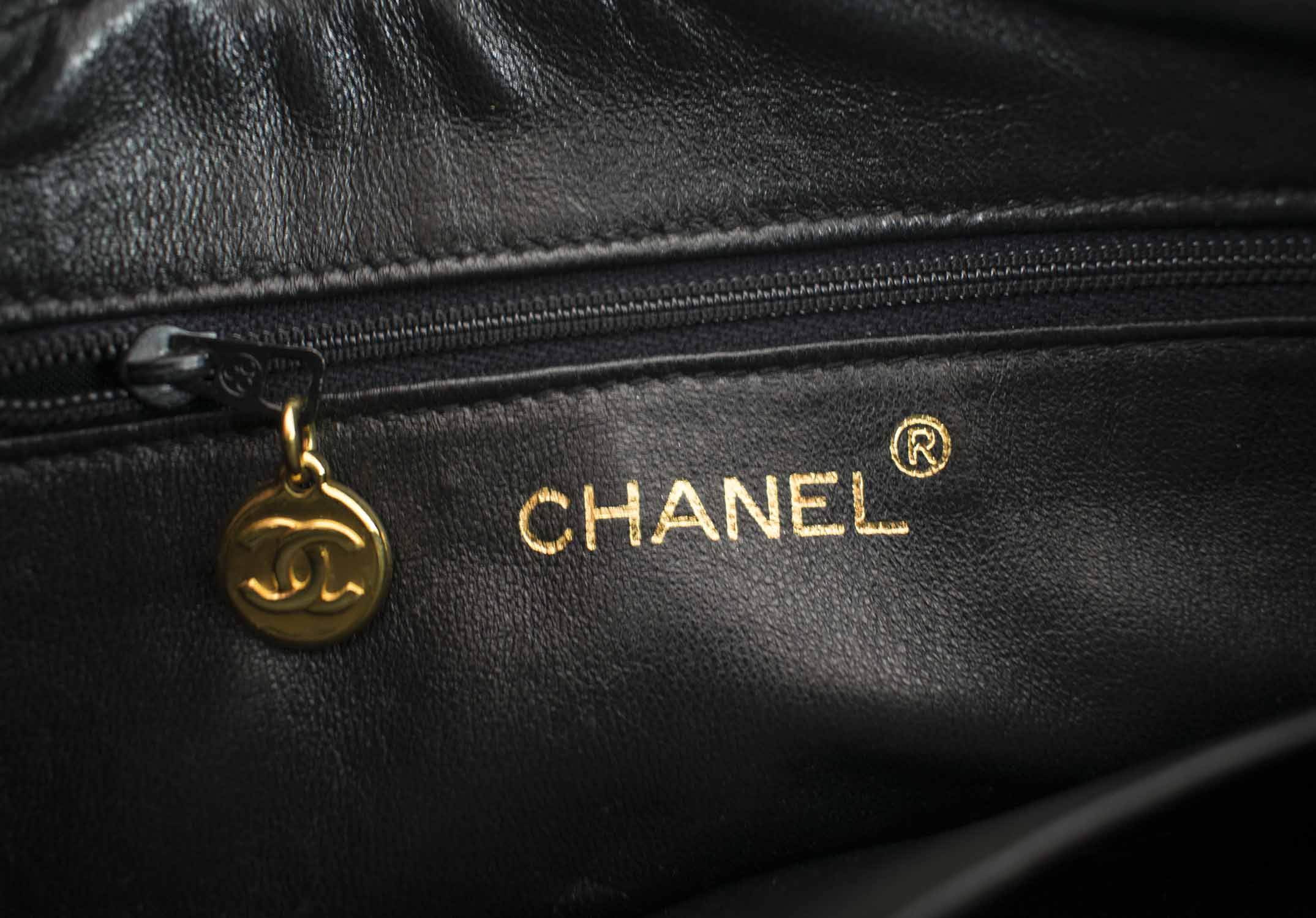 CHANEL CAMERA VINTAGE CHEVRON BAG, with top zip closure with charm pull,  one front pocket with CC turn lock closure, gold tone hardware and strap,  leather lining, authenticity card, c. 1991-1994, with