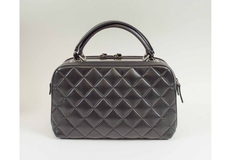 CHANEL BOWLING HANDBAG, black quilted leather with two main zippered  compartments and one front external pocket, metal gun tone hardware, one  top leather handle and one long shoulder leather and chain entwined