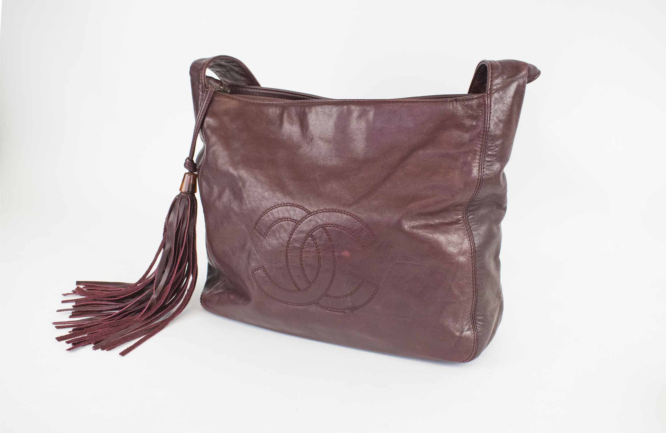 CHANEL VINTAGE SHOULDER BAG, burgundy leather with matching fabric lining,  shoulder strap and long tassel with logo, logo at the front and inside  sticker 5073721, 28cm x 26cm H x 10cm.