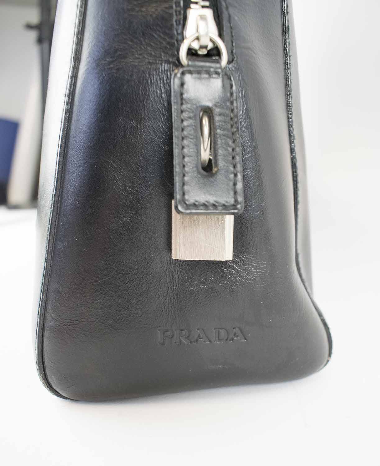 PRADA VINTAGE BAGS, one black leather with double top fabric handles