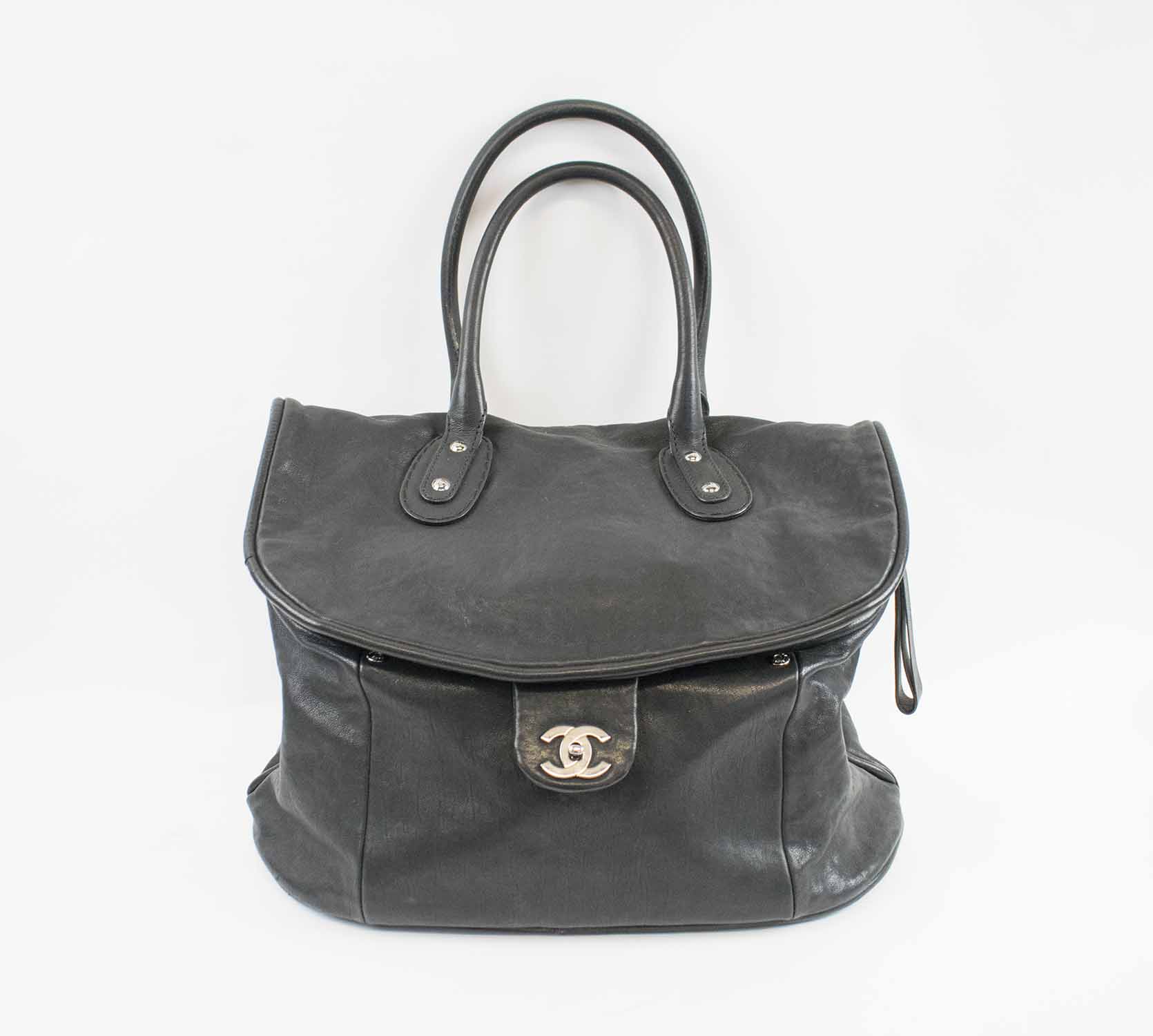 CHANEL TRAVELLING BAG, black leather with silver tone hardware, iconic