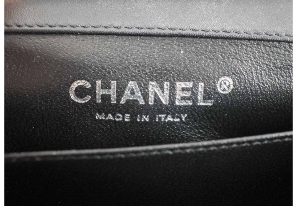 CHANEL MINI FLAP BAG, black patent leather with silver tone hardware,  shoulder chain interwoven with patent leather, leather lining, authenticity  card and inside sticker 2012-2013, two internal pockets, 17cm x 11cm.