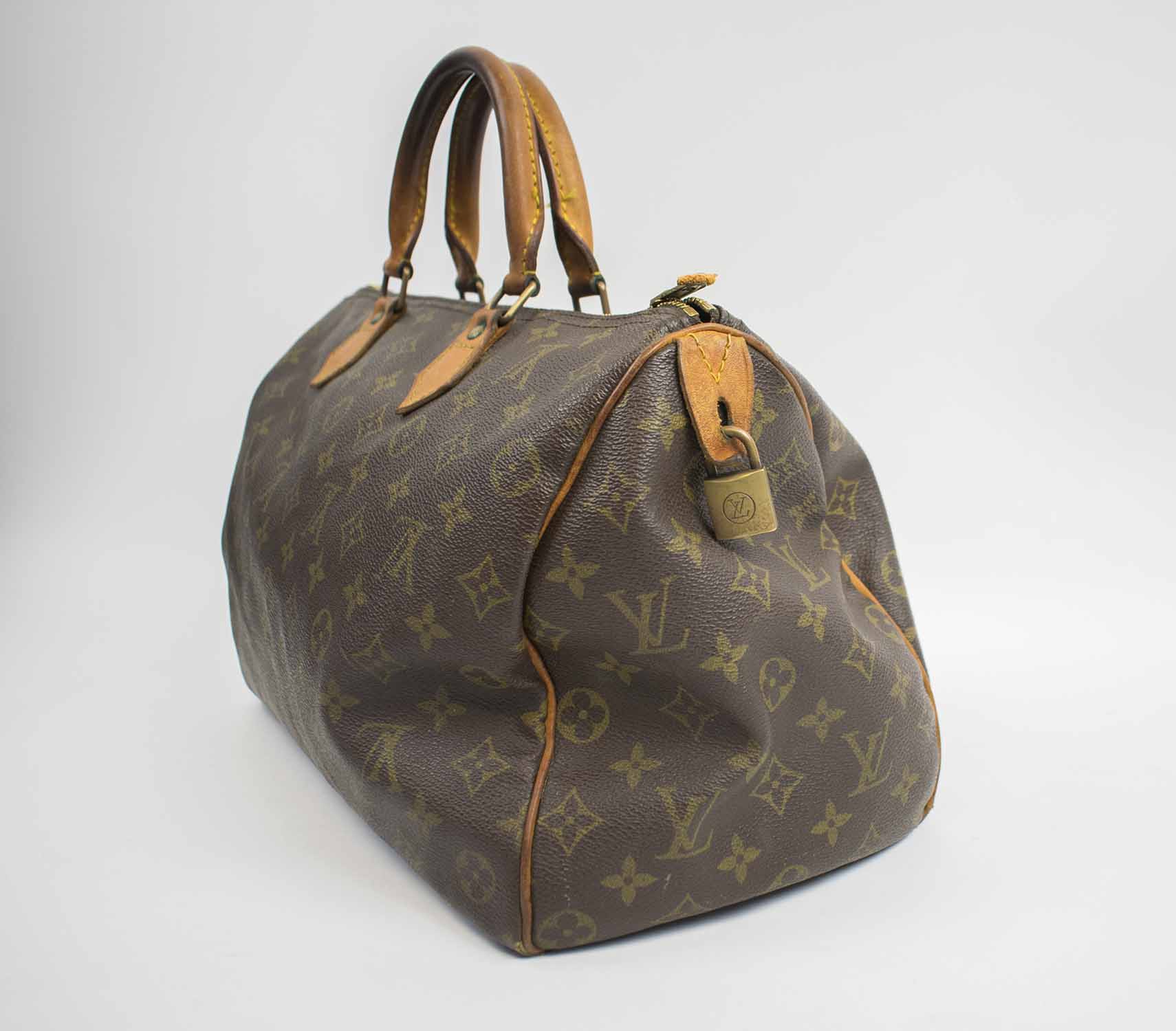 LOUIS VUITTON 35 SPEEDY BAG, with monogram coated canvas and leather trims, brass tone hardware ...