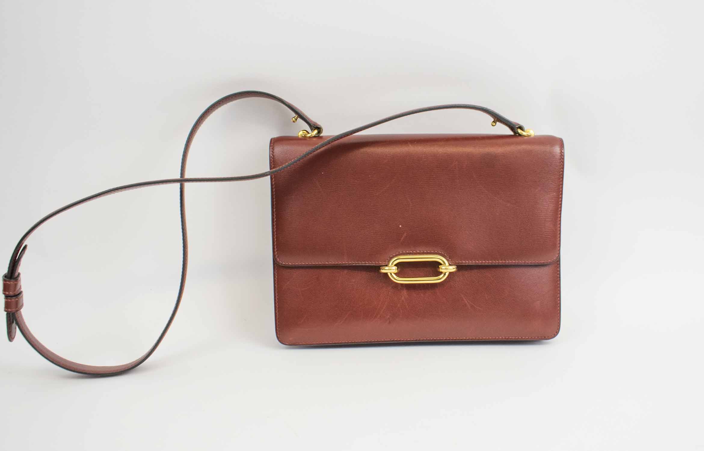 HERMES COCKTAIL SHOULDER BAG, burgundy box calf leather, flap front with an  oval closure that clips into the clasp, front slot section and few others  one with snap closure, gold tone hardware