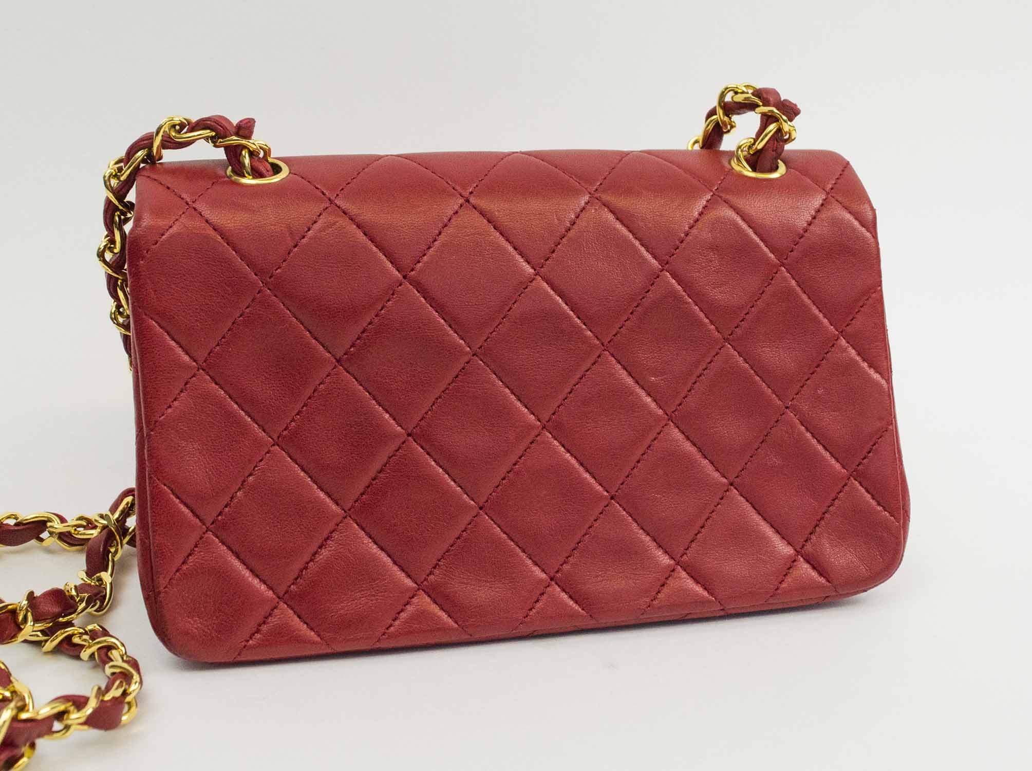 CHANEL MINI FLAP BAG, quilted red leather with gold tone hardware
