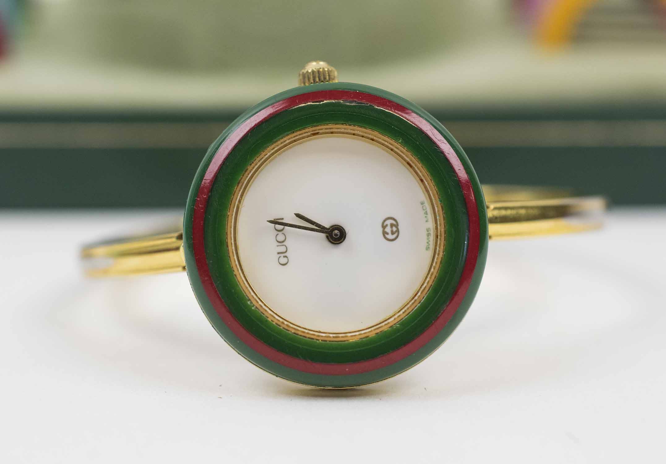 VINTAGE GUCCI WRIST WATCH, with eleven various coloured bezels (twelve in  total), in working condition, boxed with documentation and card of  authenticity.